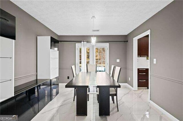 dining area featuring a textured ceiling