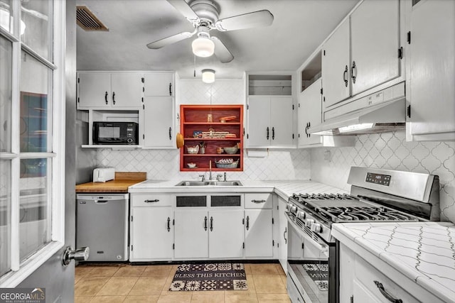 kitchen featuring white cabinetry, sink, appliances with stainless steel finishes, and tasteful backsplash