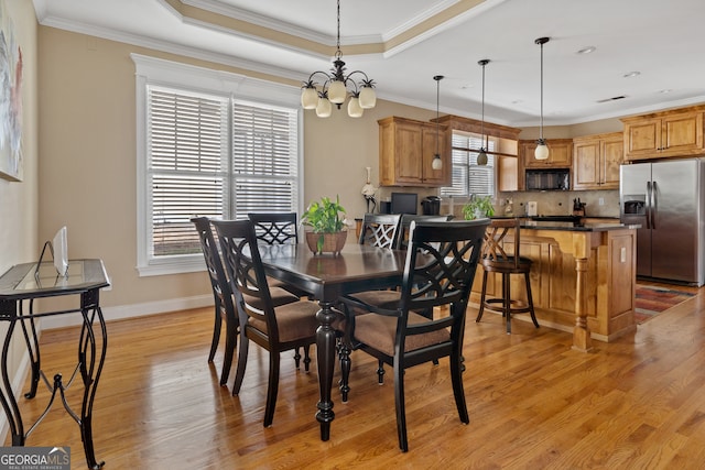 dining area featuring plenty of natural light, light hardwood / wood-style floors, and ornamental molding