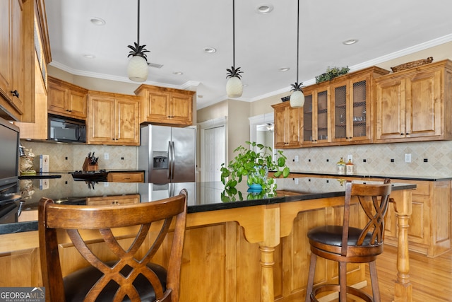 kitchen with stainless steel refrigerator with ice dispenser, tasteful backsplash, crown molding, light hardwood / wood-style floors, and hanging light fixtures