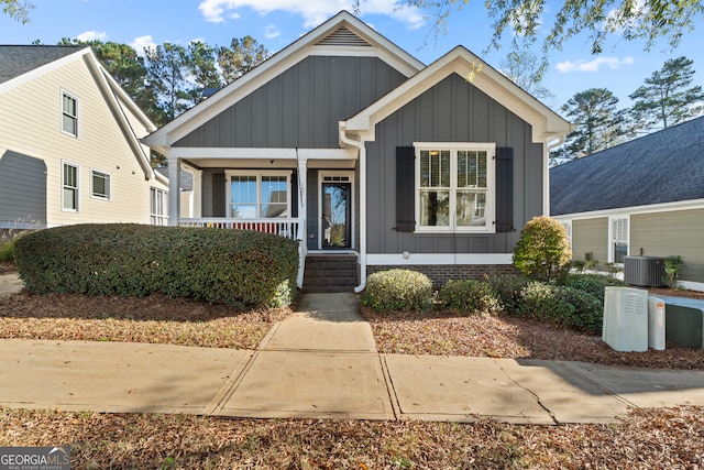 view of front of house featuring a porch and cooling unit