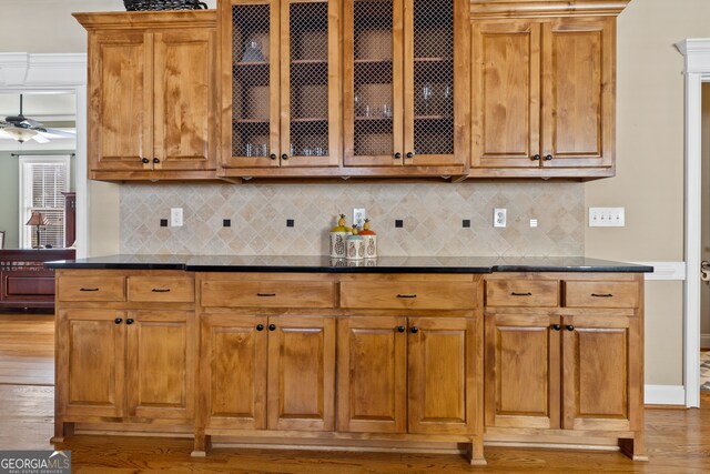 kitchen featuring backsplash, light hardwood / wood-style floors, and ceiling fan