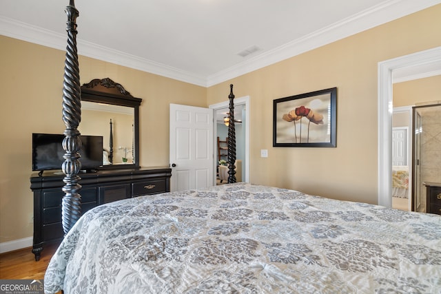 bedroom with wood-type flooring and crown molding