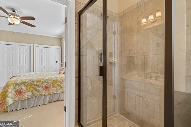 bathroom with ceiling fan, an enclosed shower, and ornamental molding