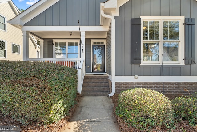 view of exterior entry featuring a porch