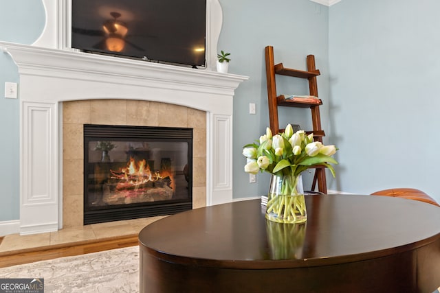 details with a tile fireplace and hardwood / wood-style floors