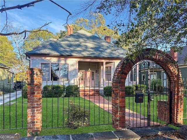 bungalow-style home with a front yard and a porch