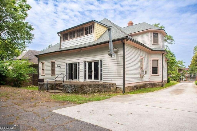 rear view of property featuring cooling unit