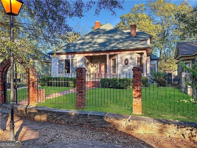 bungalow-style house with a front lawn