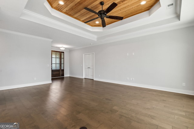 unfurnished room with ceiling fan, dark wood-type flooring, wooden ceiling, a raised ceiling, and crown molding