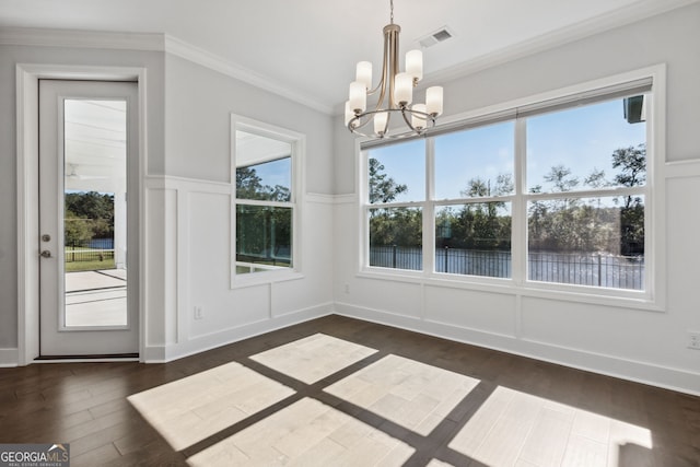 unfurnished dining area featuring dark hardwood / wood-style floors, a wealth of natural light, and a chandelier