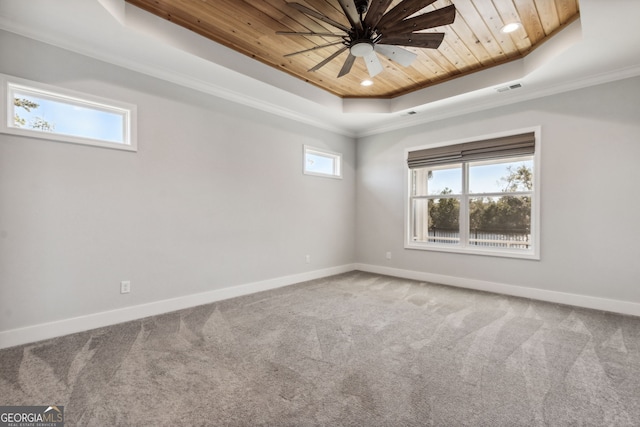 spare room featuring ceiling fan, wooden ceiling, a raised ceiling, carpet, and ornamental molding