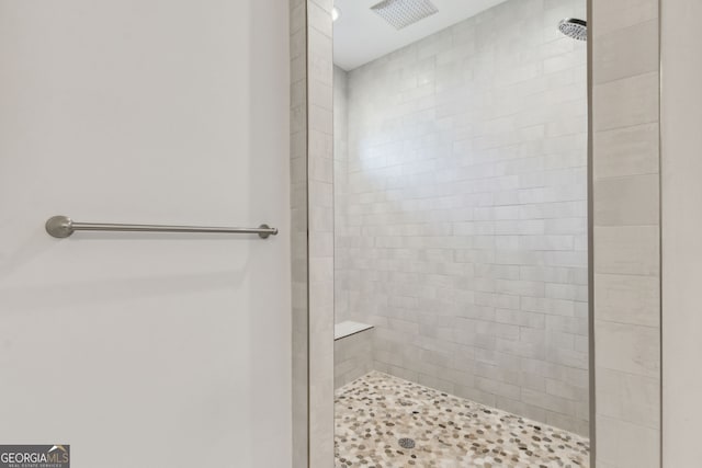 bathroom with tiled shower