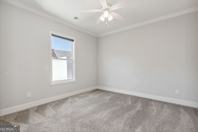 spare room featuring carpet flooring, ceiling fan, and crown molding