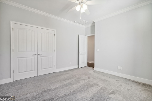 unfurnished bedroom with ceiling fan, ornamental molding, light carpet, and a closet