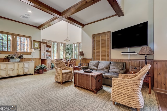 living room with beam ceiling, light hardwood / wood-style flooring, ornamental molding, and wooden walls