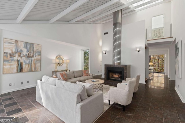 living room featuring beam ceiling, wooden ceiling, and high vaulted ceiling