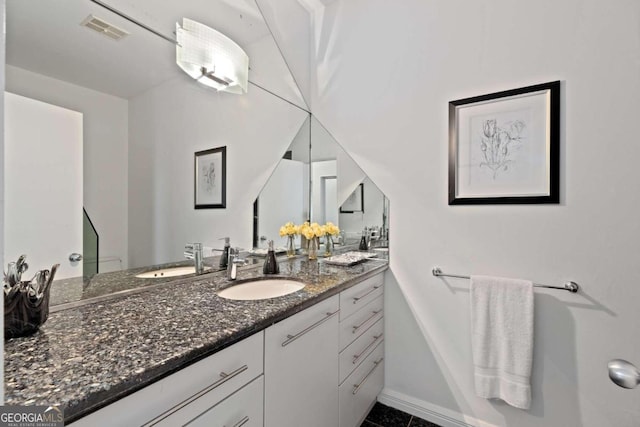 bathroom featuring tile patterned flooring and vanity