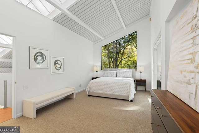 carpeted bedroom featuring beam ceiling, wood ceiling, and high vaulted ceiling