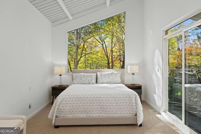 carpeted bedroom featuring access to outside and lofted ceiling