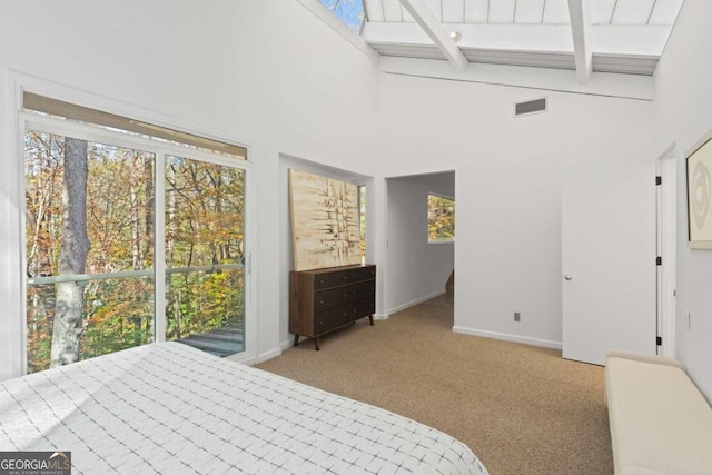 carpeted bedroom featuring beamed ceiling and high vaulted ceiling