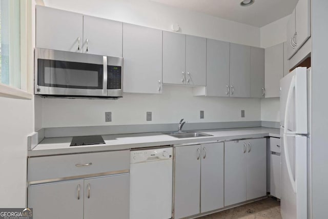 kitchen with gray cabinets, white appliances, and sink