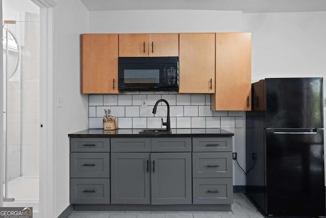 kitchen with decorative backsplash, gray cabinetry, and black appliances