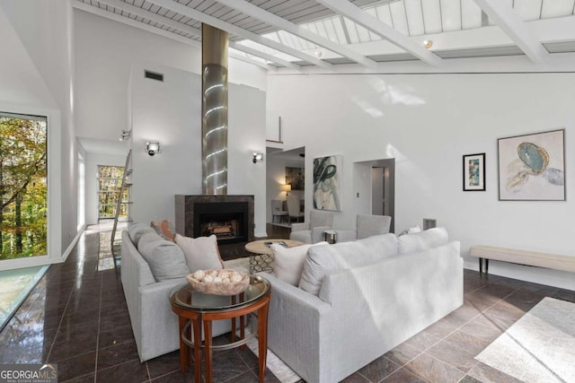 living room with beamed ceiling, high vaulted ceiling, and wood ceiling