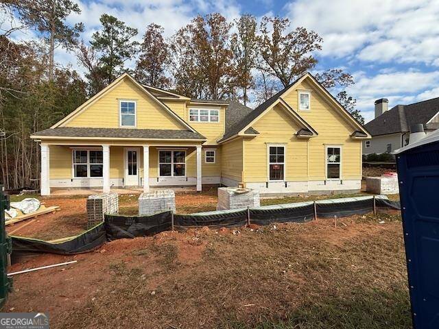 rear view of house featuring a porch