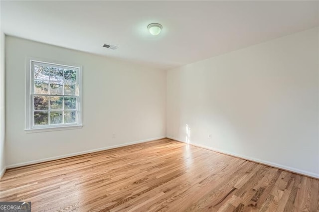 spare room featuring light wood-type flooring