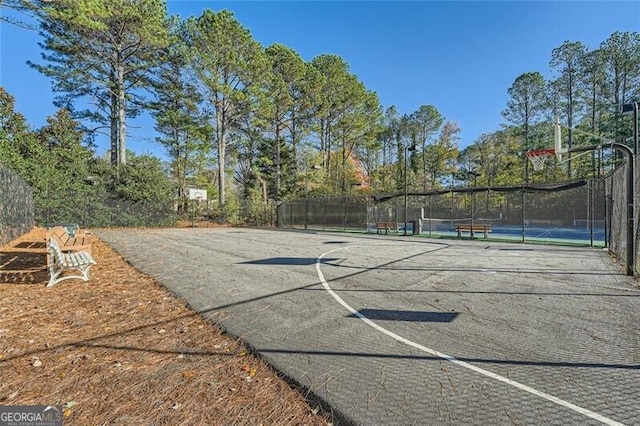 view of basketball court featuring tennis court