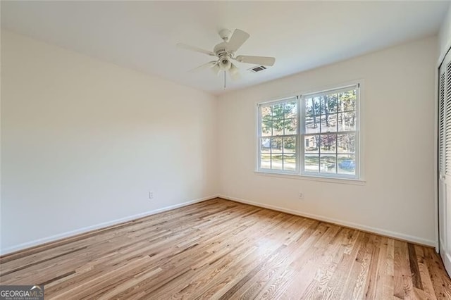 spare room featuring light wood-type flooring and ceiling fan