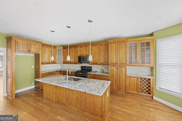 727 Pear Grove Pl, Marietta, GA 30066 - kitchen featuring stainless steel range with gas cooktop, a sink, brown cabinetry, light wood-style floors, and recessed lighting