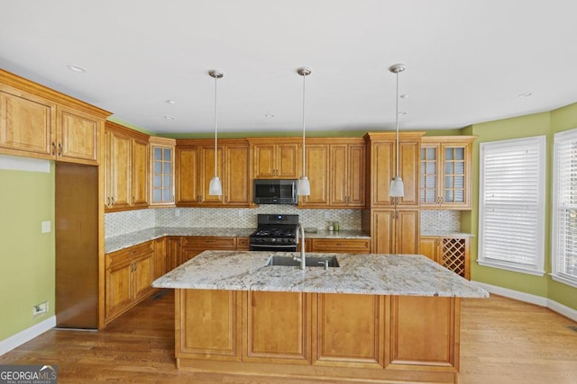 727 Pear Grove Pl, Marietta, GA 30066 - kitchen featuring stainless steel microwave, gas stove, brown cabinets, a sink, and tasteful backsplash