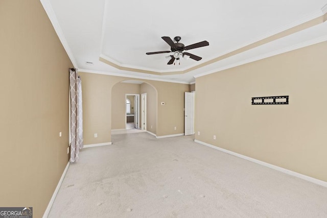 727 Pear Grove Pl, Marietta, GA 30066 - carpeted spare room with a tray ceiling, arched walkways, ceiling fan, crown molding, and baseboards