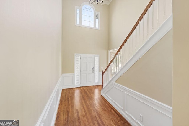 727 Pear Grove Pl, Marietta, GA 30066 - foyer featuring stairway, a decorative wall, a high ceiling, a chandelier, and wood finished floors