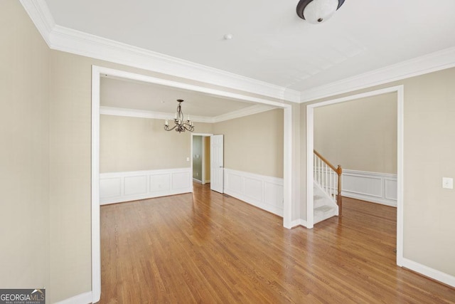 727 Pear Grove Pl, Marietta, GA 30066 - spare room featuring a chandelier, wood finished floors, crown molding, stairway, and wainscoting