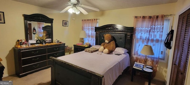 bedroom with ceiling fan and carpet floors