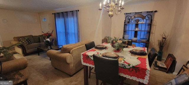 dining room featuring carpet flooring and a chandelier