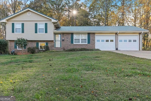 tri-level home featuring a garage and a front lawn