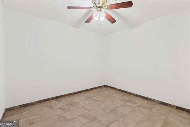 6166 Laurel Wood Trl, Flowery Branch, GA 30542 - spare room featuring a ceiling fan and baseboards