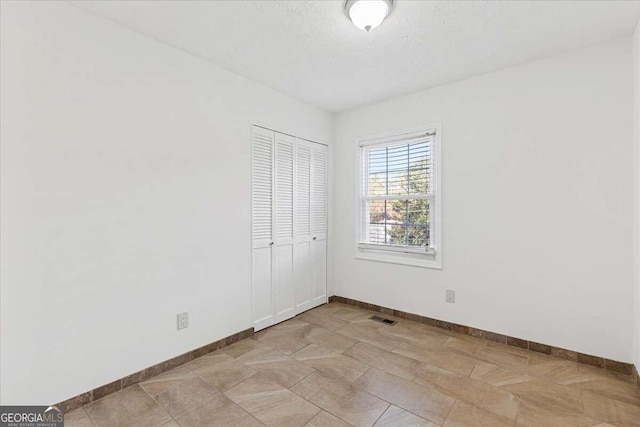 spare room with a textured ceiling