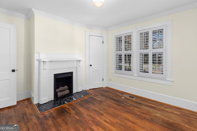 unfurnished living room with ornamental molding, dark wood-type flooring, and a brick fireplace