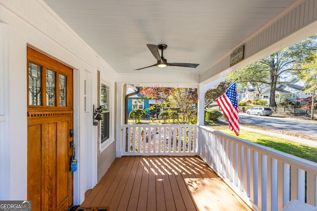 wooden terrace featuring ceiling fan and covered porch