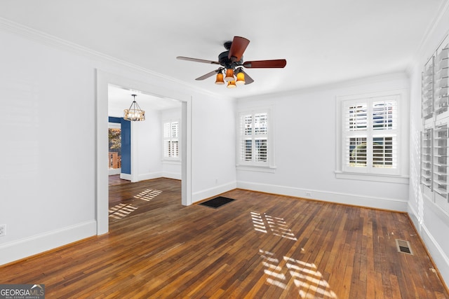 unfurnished room with dark hardwood / wood-style flooring, ceiling fan with notable chandelier, and ornamental molding