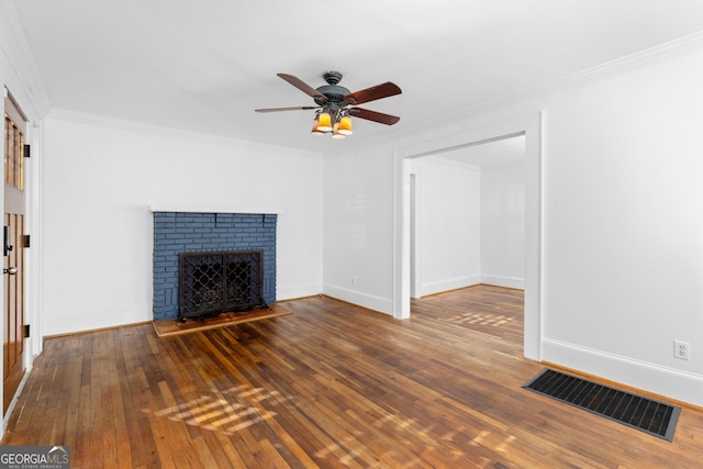 unfurnished living room with ceiling fan, ornamental molding, dark wood-type flooring, and a brick fireplace