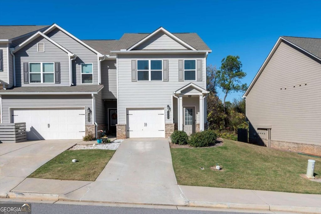 view of front of property featuring a front lawn and a garage