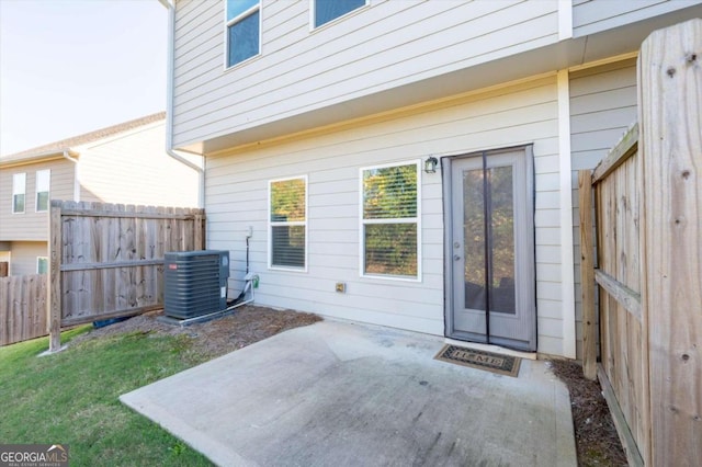 property entrance with a patio area and central AC