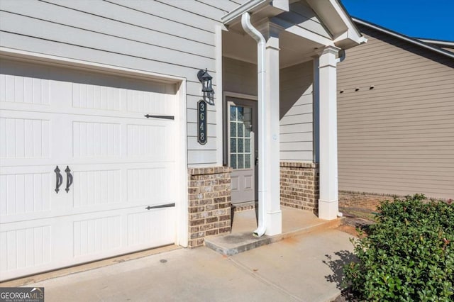 doorway to property with a garage