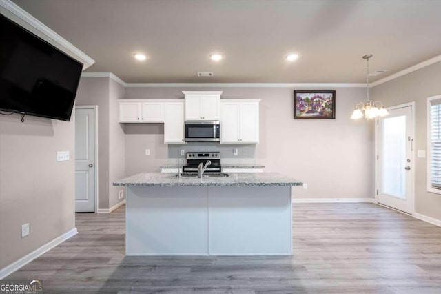 kitchen featuring white cabinetry, light stone counters, a kitchen island with sink, and appliances with stainless steel finishes